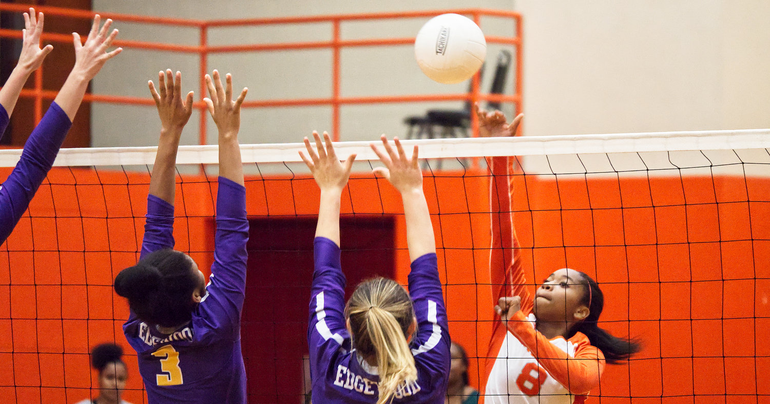 Sabria Dean displays some touch, lobbing the ball over fingertips of the would be Edgewood blockers.